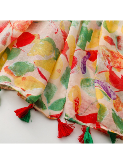 Close-up of red and green tassels along the printed scarf edge