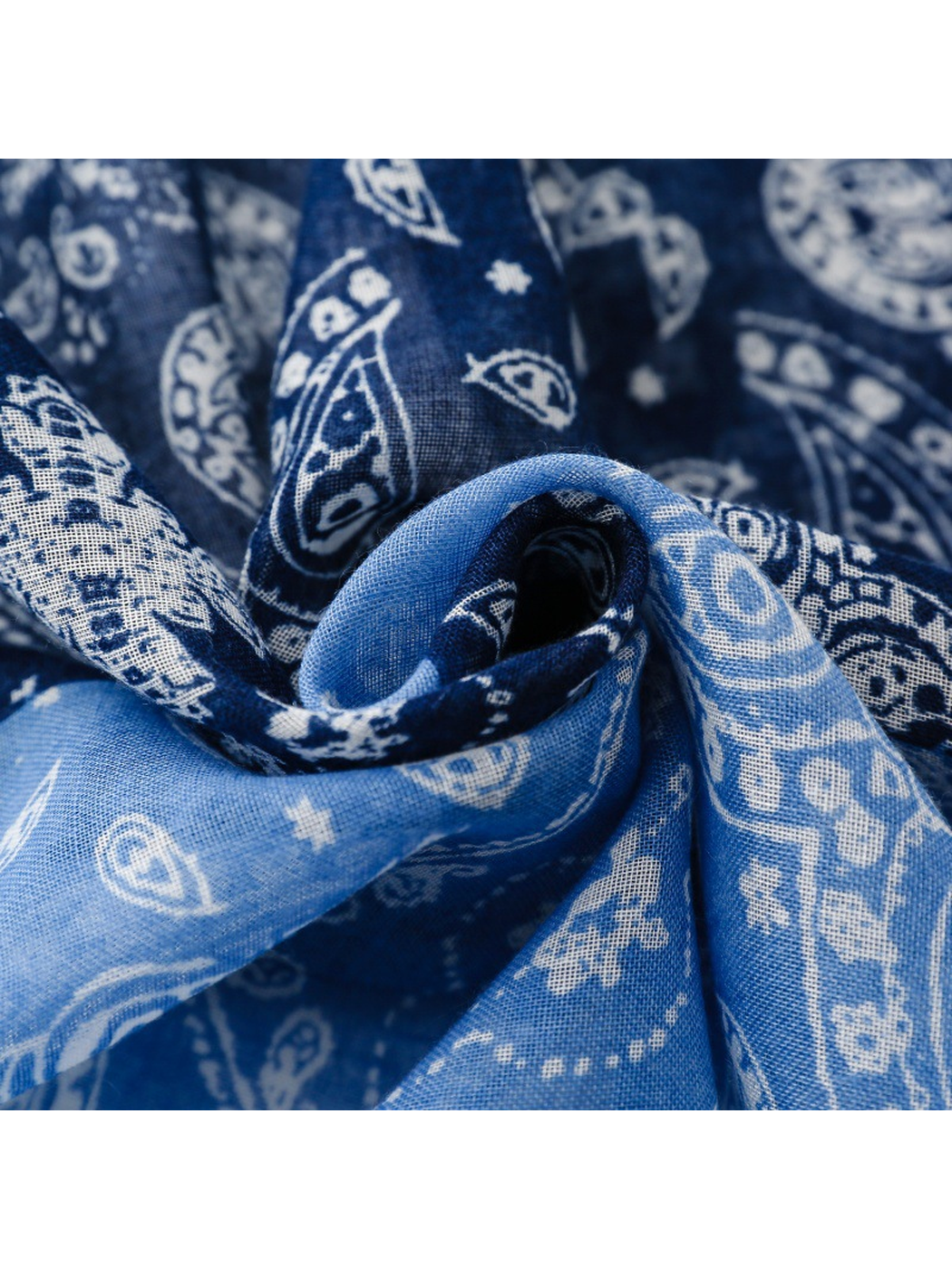 Close-up of the blue scarf's fine woven texture and paisley print