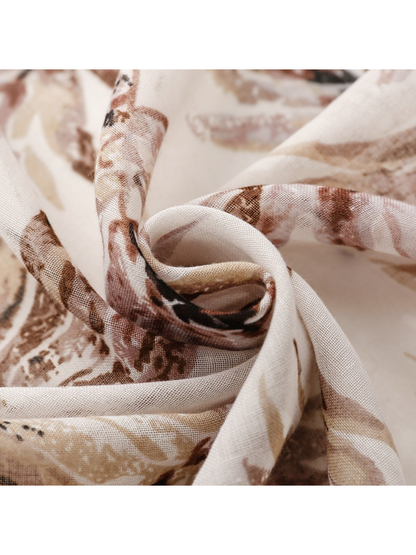 Close-up of the scarf's fine semi-sheer weave and botanical print