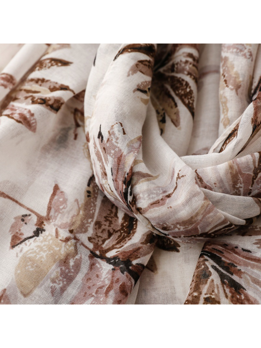 Close-up of the muted brown and dusty pink leaf print in gathered folds