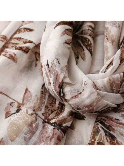 Close-up of the muted brown and dusty pink leaf print in gathered folds