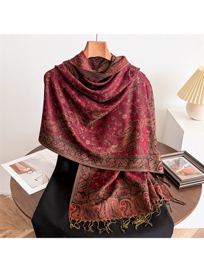 Burgundy paisley scarf draped on a display form with fringed ends