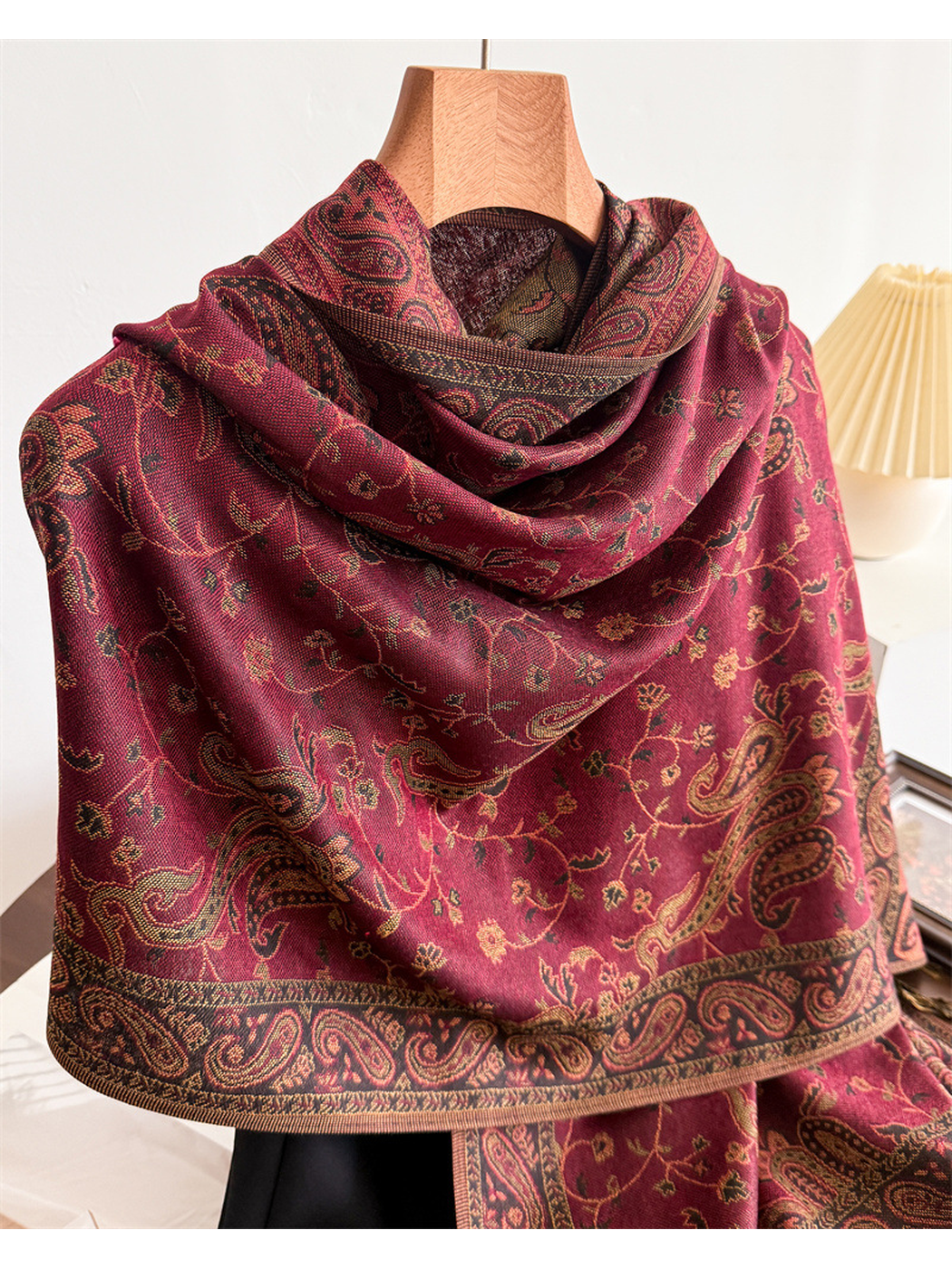 Close-up of the burgundy scarf drape and contrasting paisley border