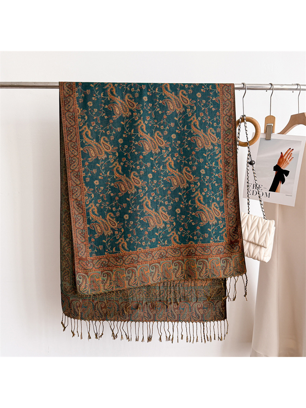 Deep teal paisley scarf displayed flat with its rectangular border and fringe visible