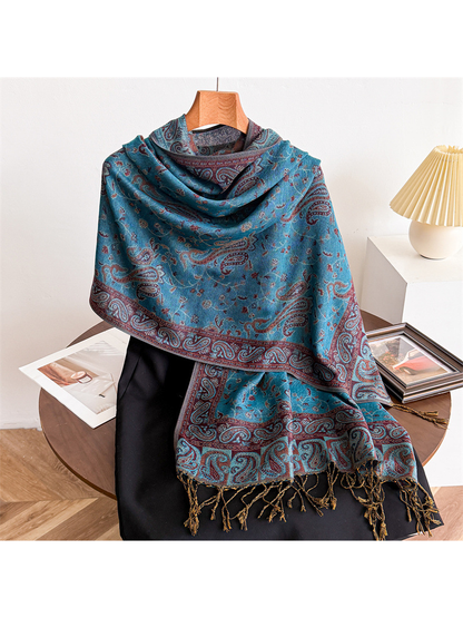Lake blue paisley scarf draped on a display form with fringed ends