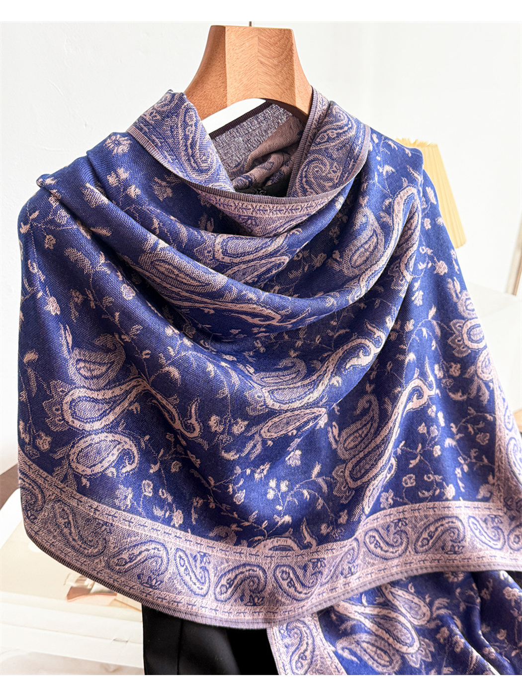 Close-up of the navy scarf's paisley motifs, floral vines and border