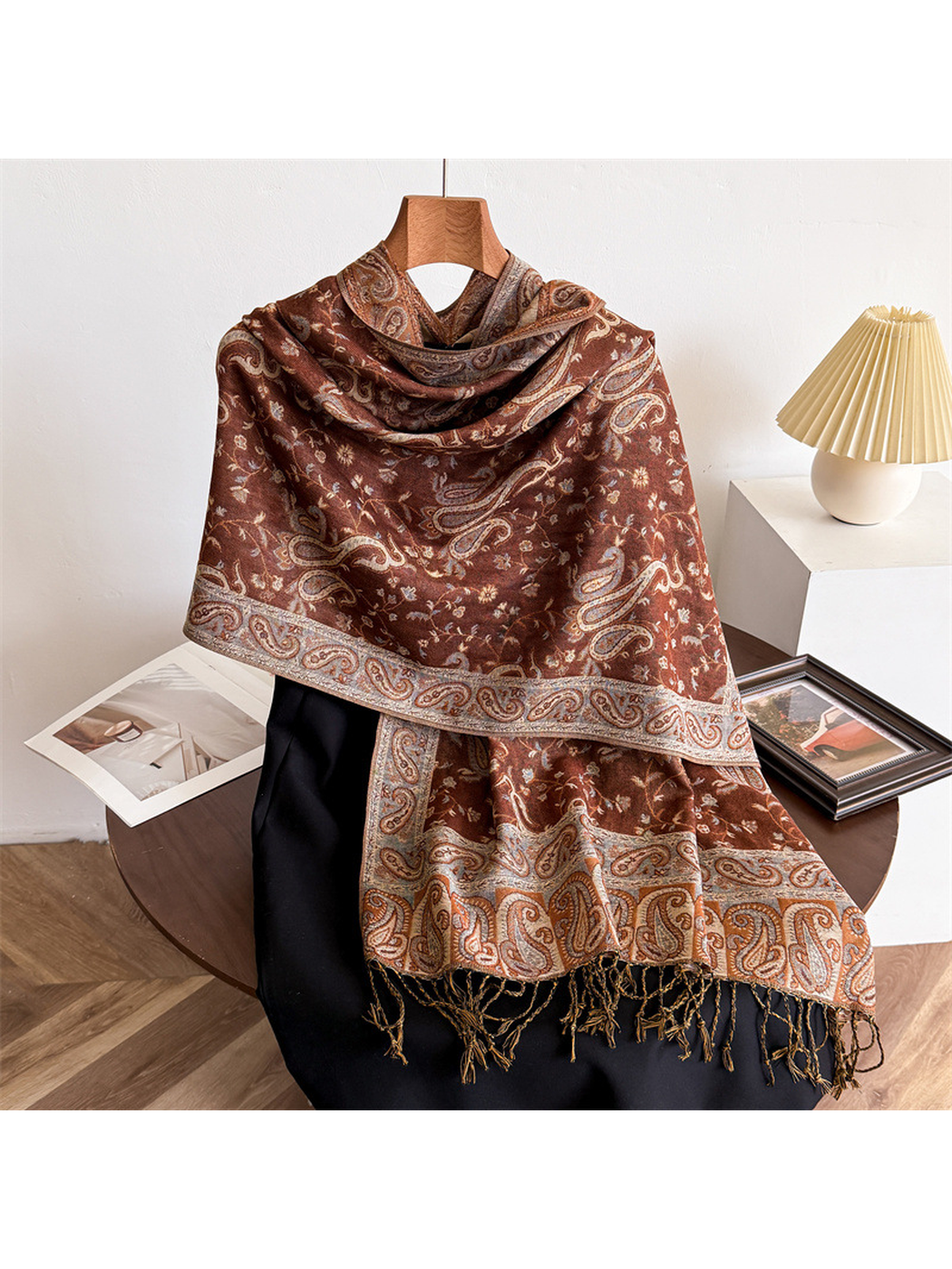 Caramel brown paisley scarf draped on a display form with fringed ends