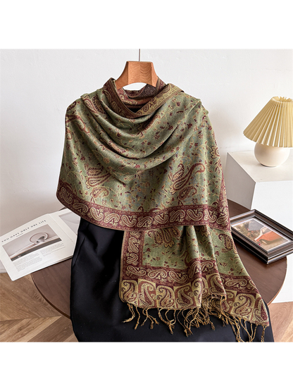 Moss green paisley scarf draped on a display form with fringed ends