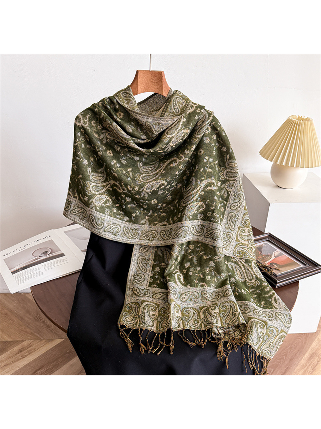 Army green paisley scarf draped on a display form with fringed ends