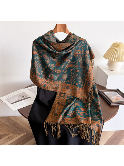 Deep teal green paisley scarf draped with a warm brown border and twisted fringe