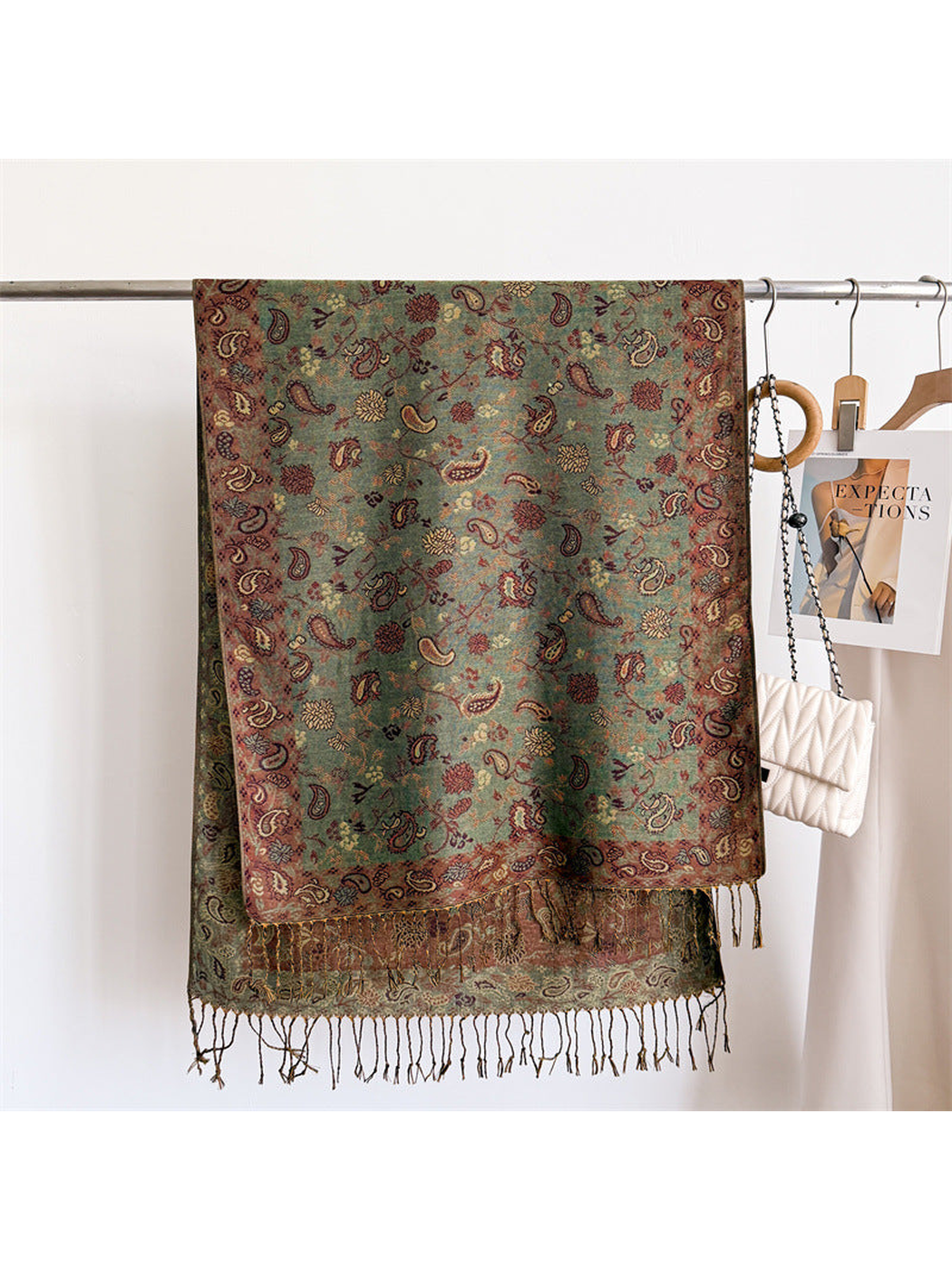 Sage green paisley scarf displayed flat with a muted rose border and fringe