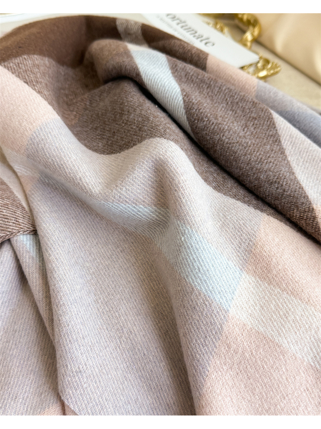 Close-up of the brown, blush and gray plaid weave
