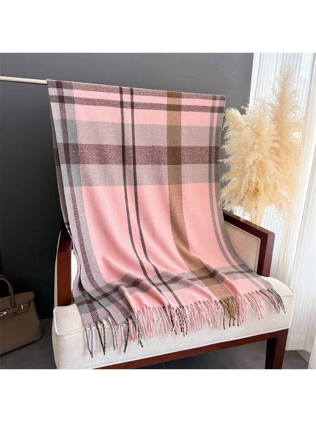Pink plaid scarf displayed full length with fringed ends