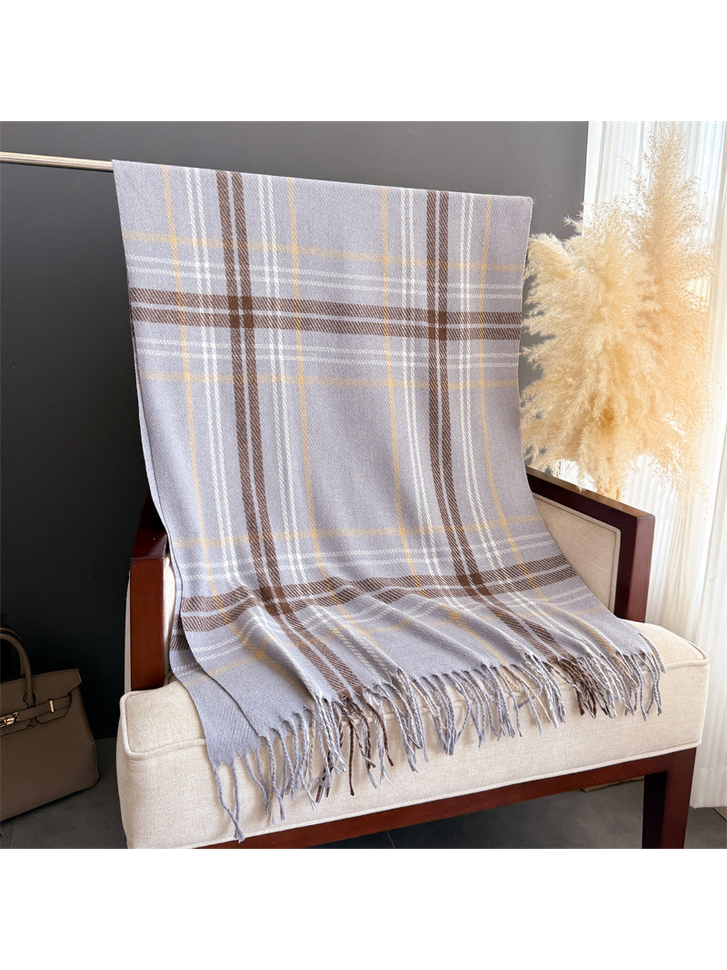 Gray plaid fringed scarf displayed at full length