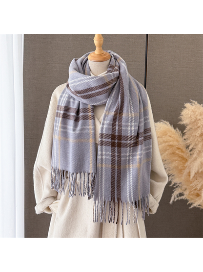 Gray plaid fringed scarf draped around a mannequin