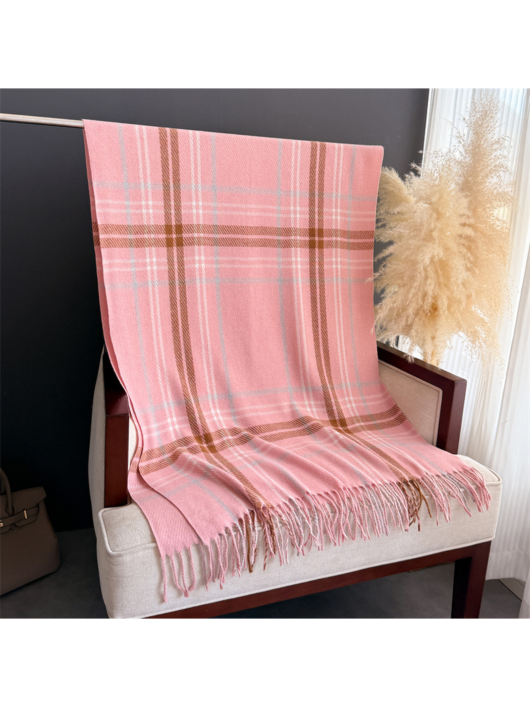 Pink plaid fringed scarf displayed at full length