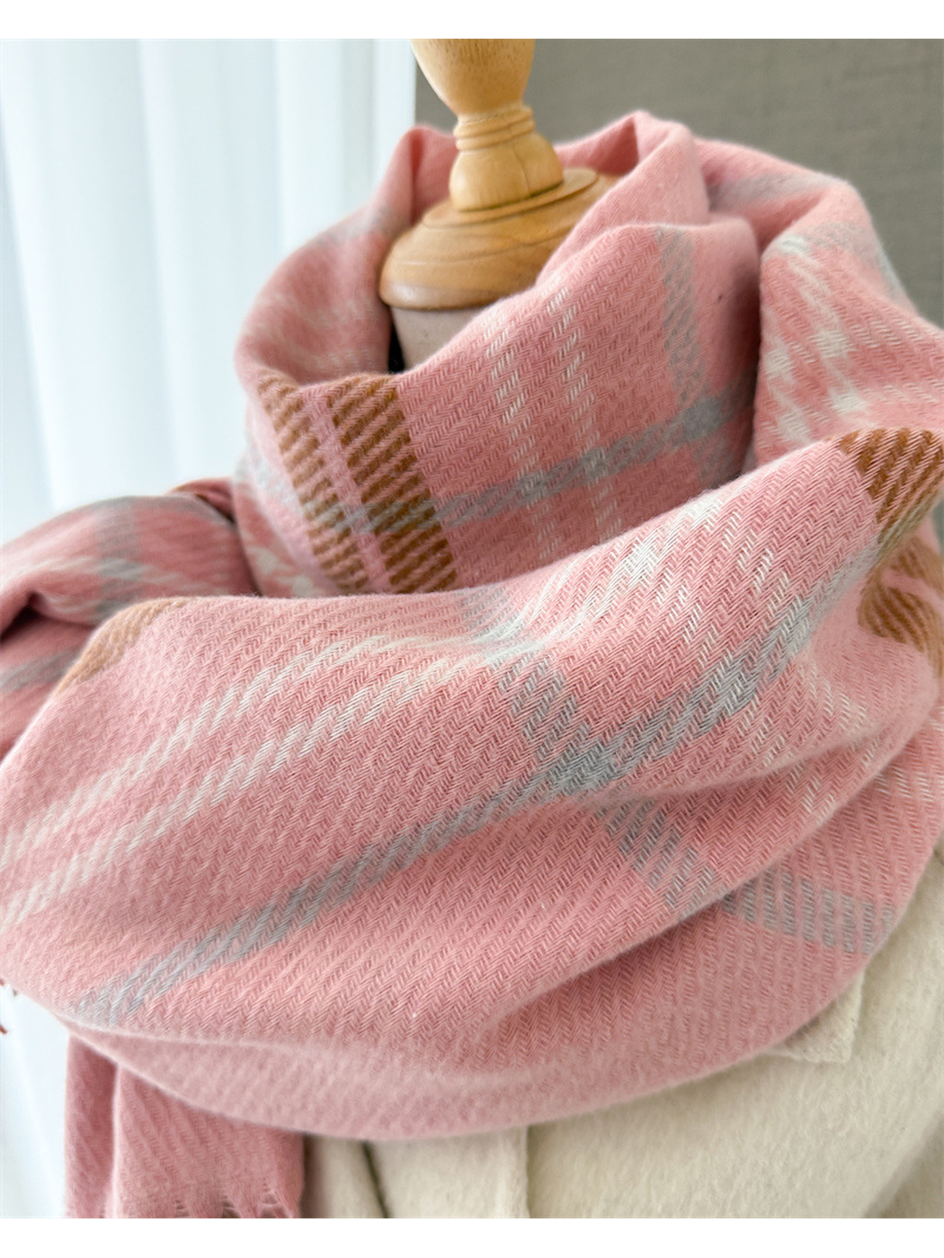 Close-up of pink scarf folds and fine plaid weave