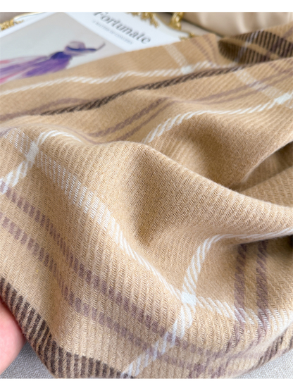 Close-up of camel plaid scarf folds and herringbone weave