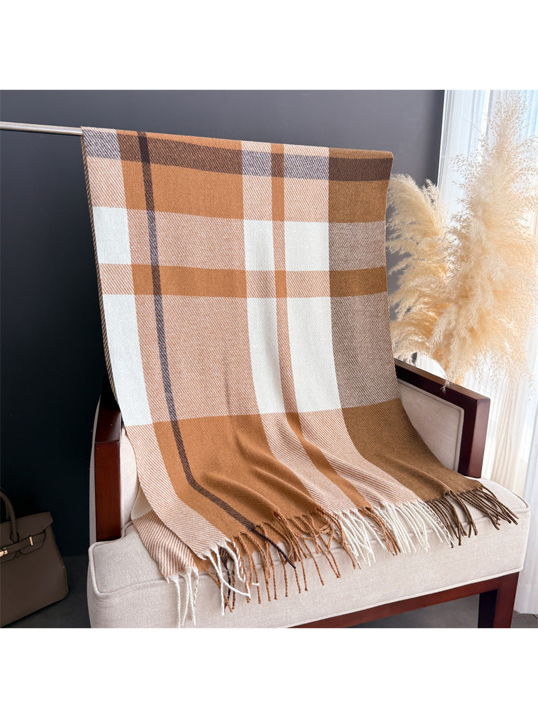 Brown, cream and gray plaid scarf draped to show its rectangular shape and fringed edges