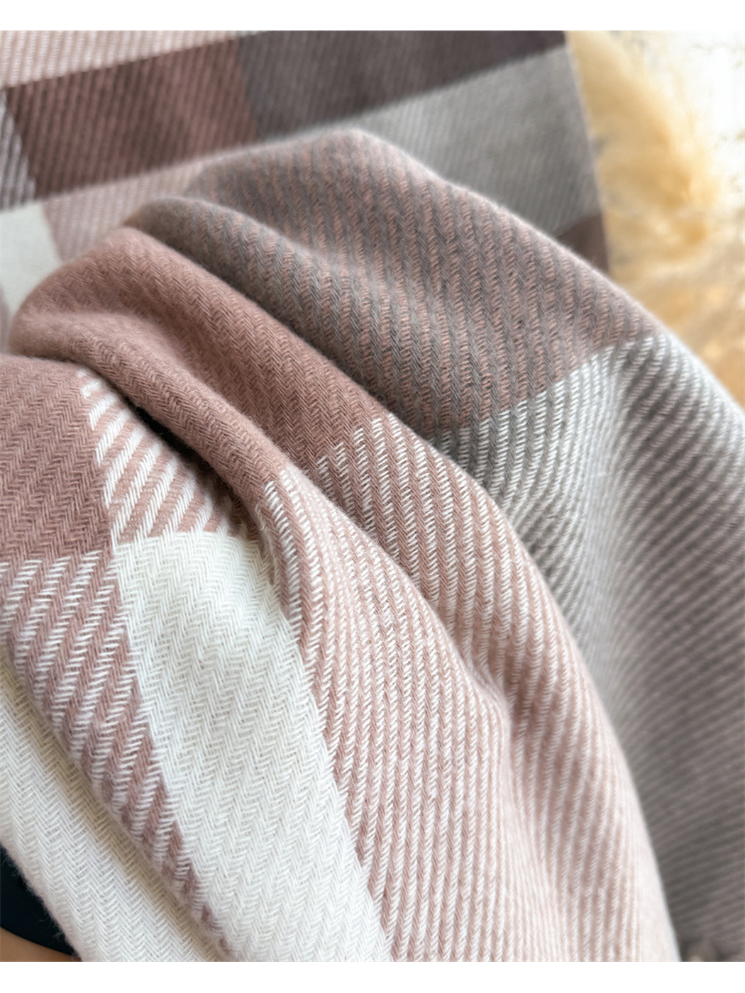 Close-up of the plaid scarf's fine herringbone weave and intersecting color blocks
