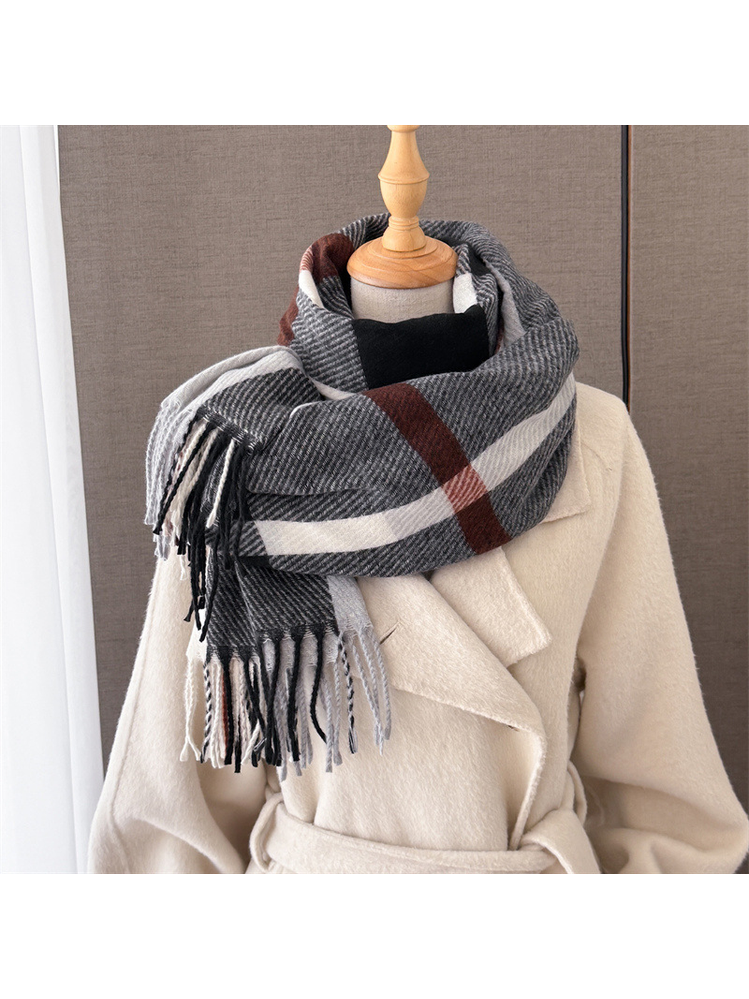 Charcoal, white and rust plaid scarf wrapped on a mannequin