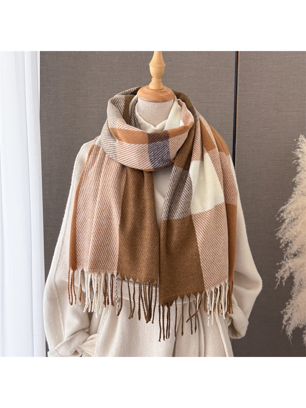 Brown, caramel and ivory plaid scarf styled on a cream mannequin