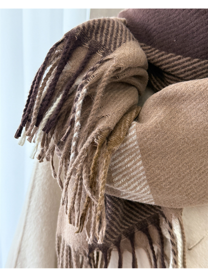 Close-up of twisted fringe and herringbone weave on the brown plaid scarf