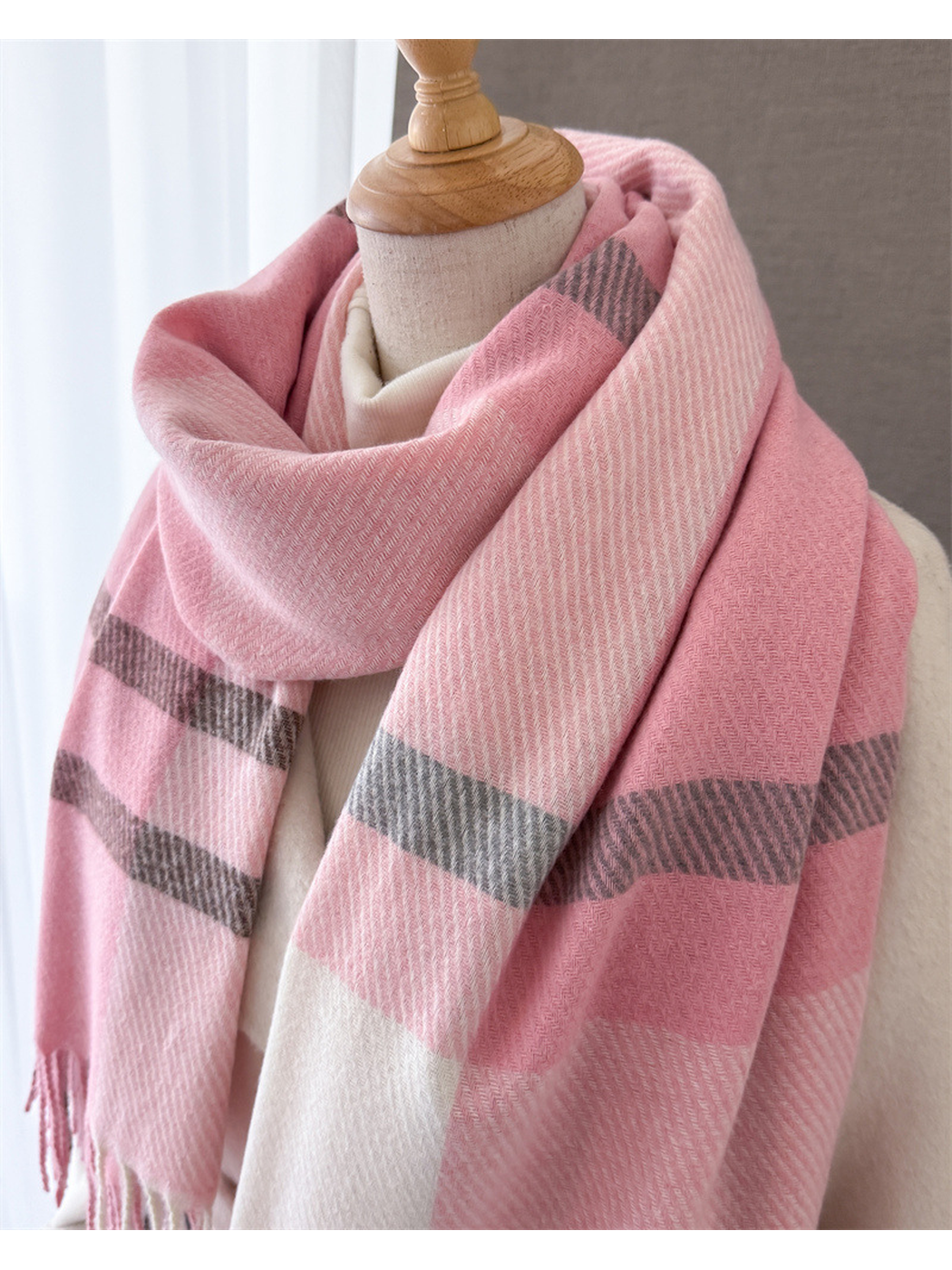 Close-up of the pink plaid scarf wrapped around a mannequin