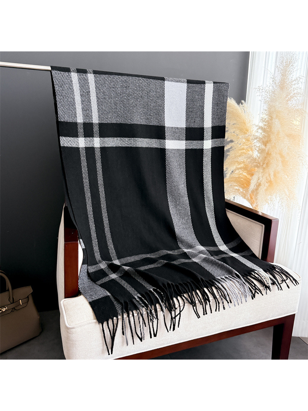Black and gray plaid rectangular scarf with fringe displayed full length