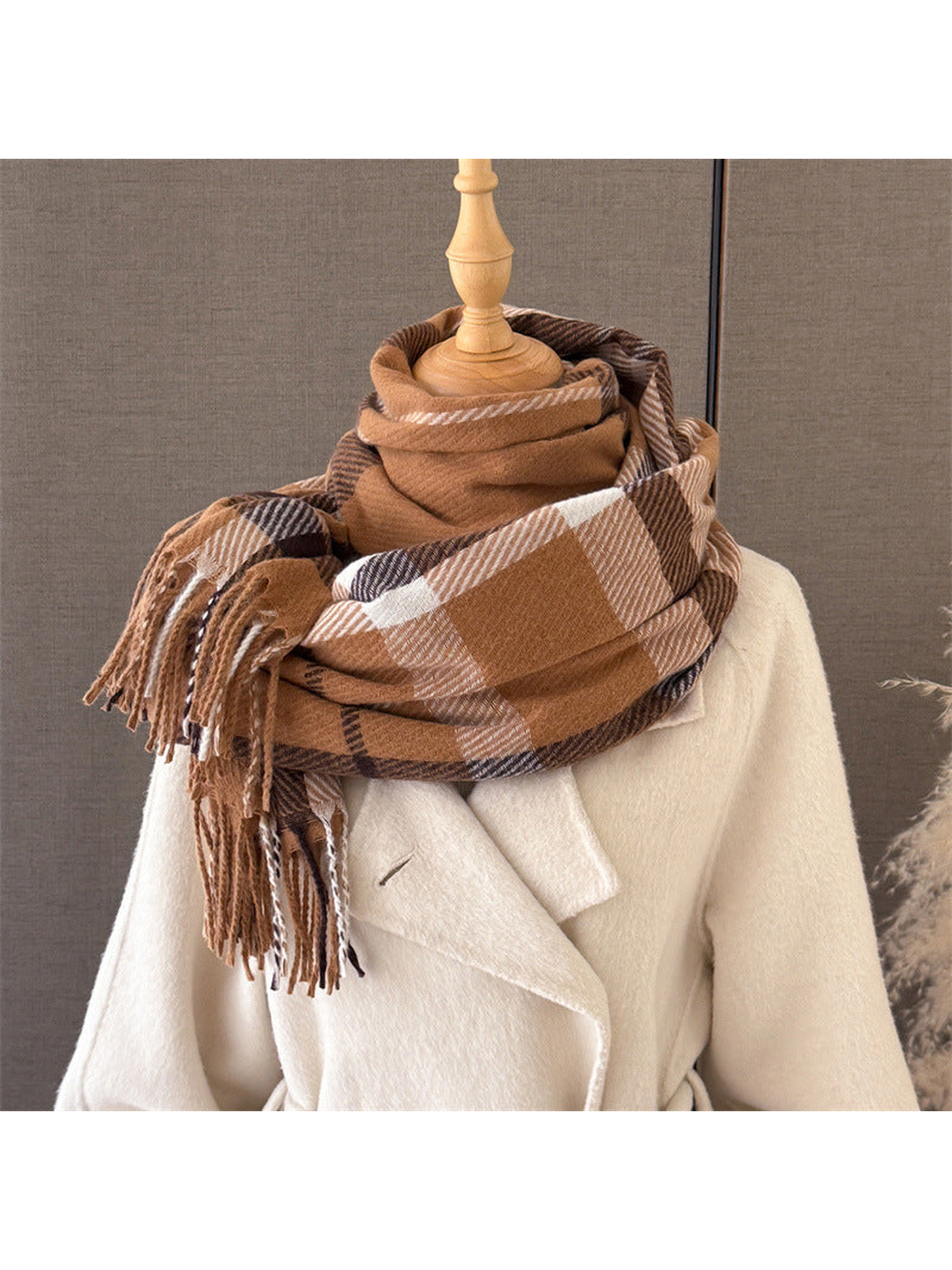Camel plaid scarf wrapped on a dress form with fringed ends