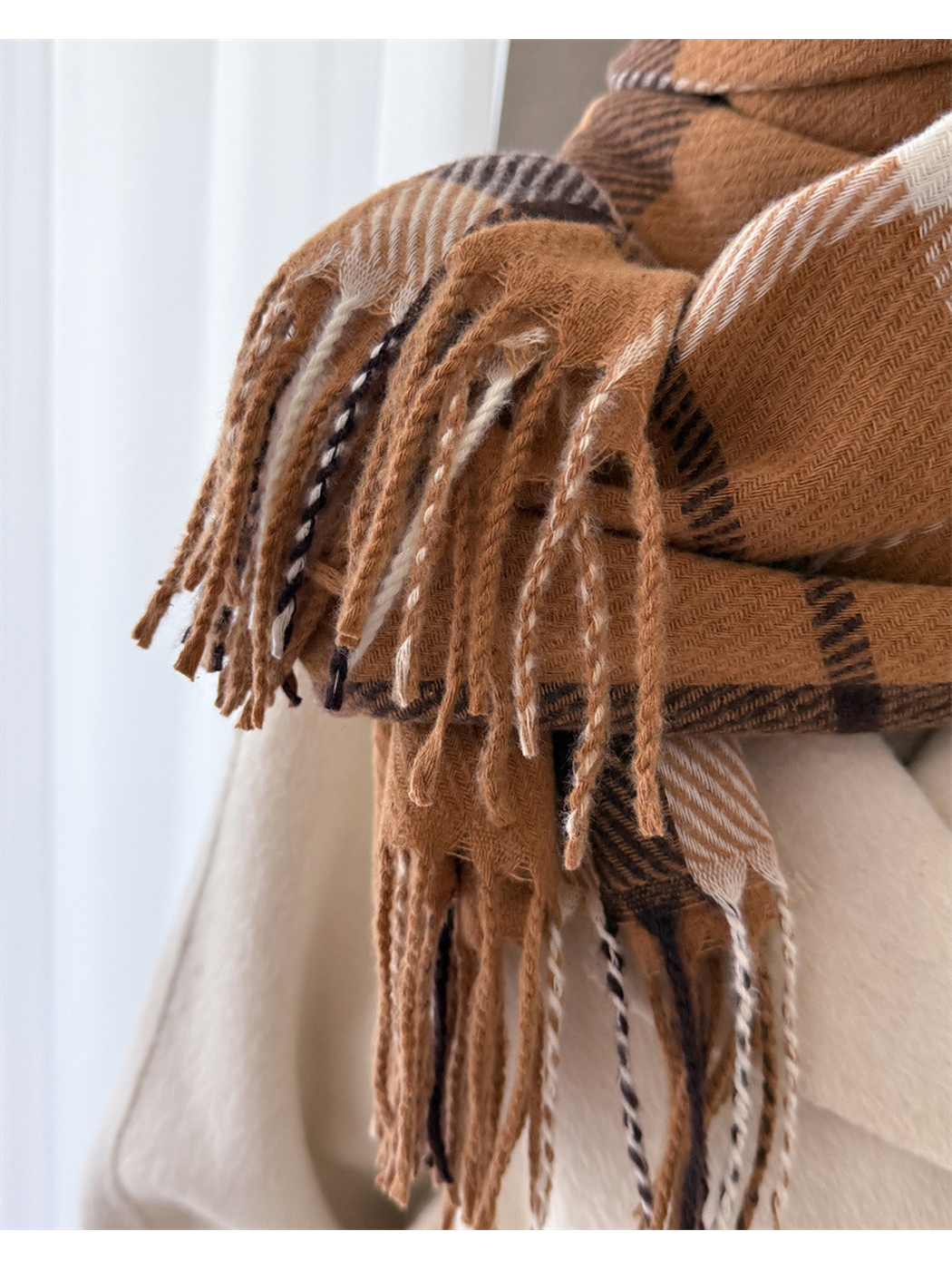 Close-up of twisted multicolor fringe along the scarf edge