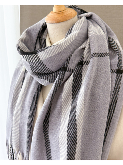 Close-up of the light gray scarf's draped plaid pattern and woven texture
