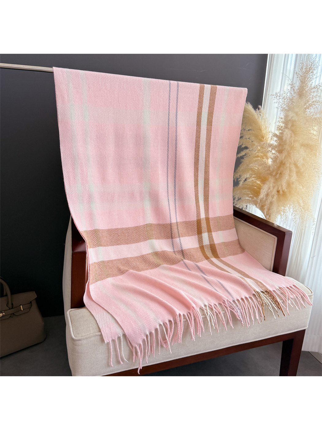 Light pink plaid rectangular scarf displayed flat with fringed ends