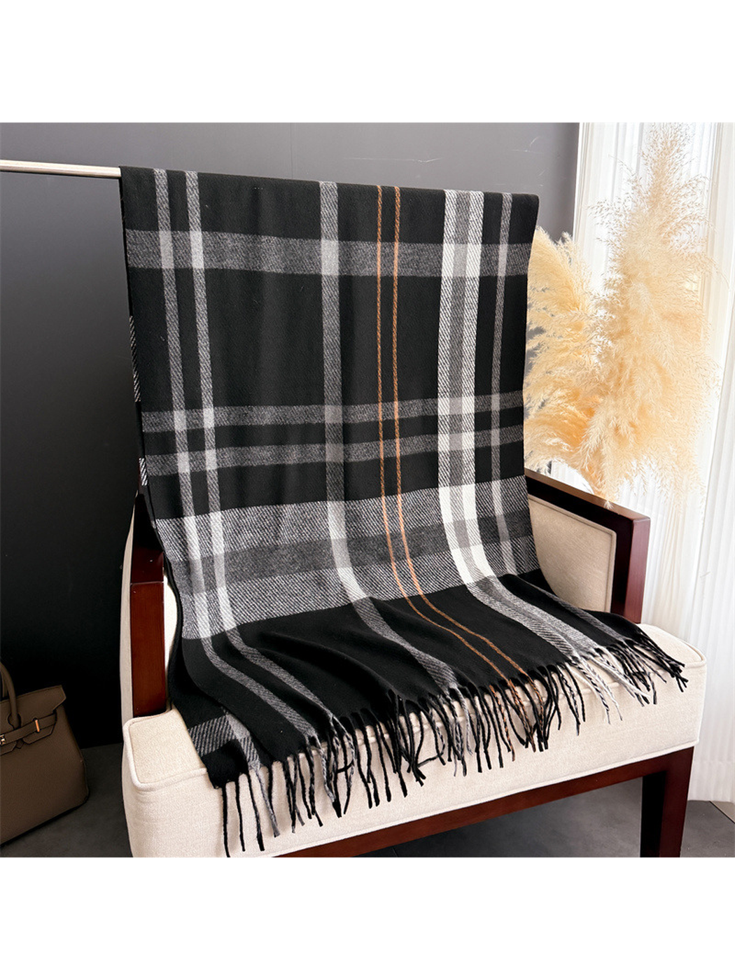 Black plaid rectangular scarf displayed flat with fringed ends