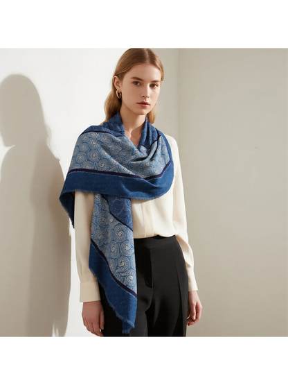 Blue paisley scarf styled across the shoulders with one end hanging in front