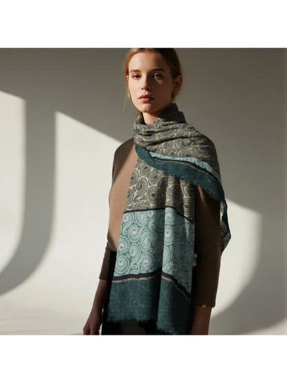 Green paisley scarf looped around the neck with both ends hanging in front