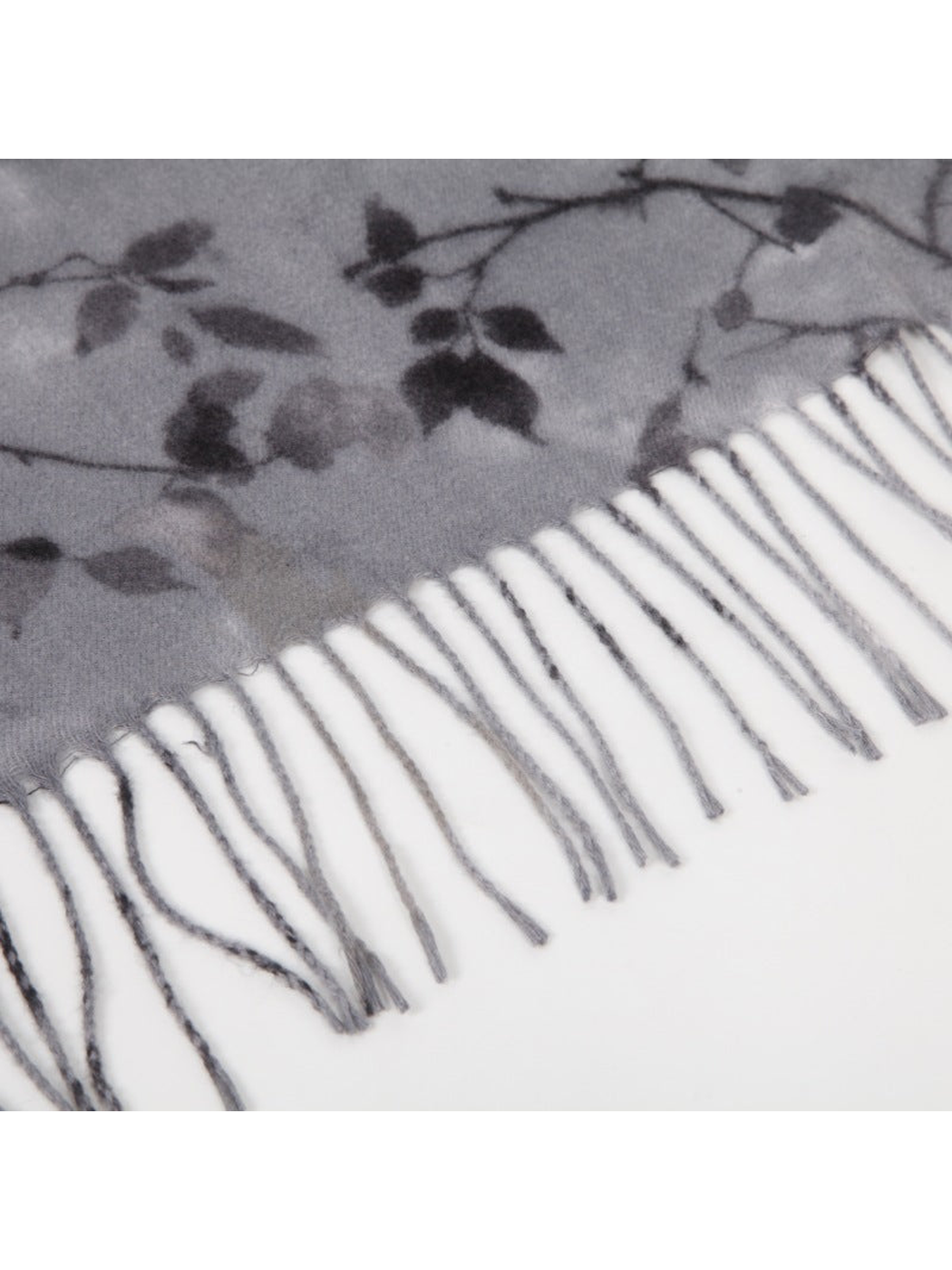 Close-up of the floral scarf edge with long twisted fringe