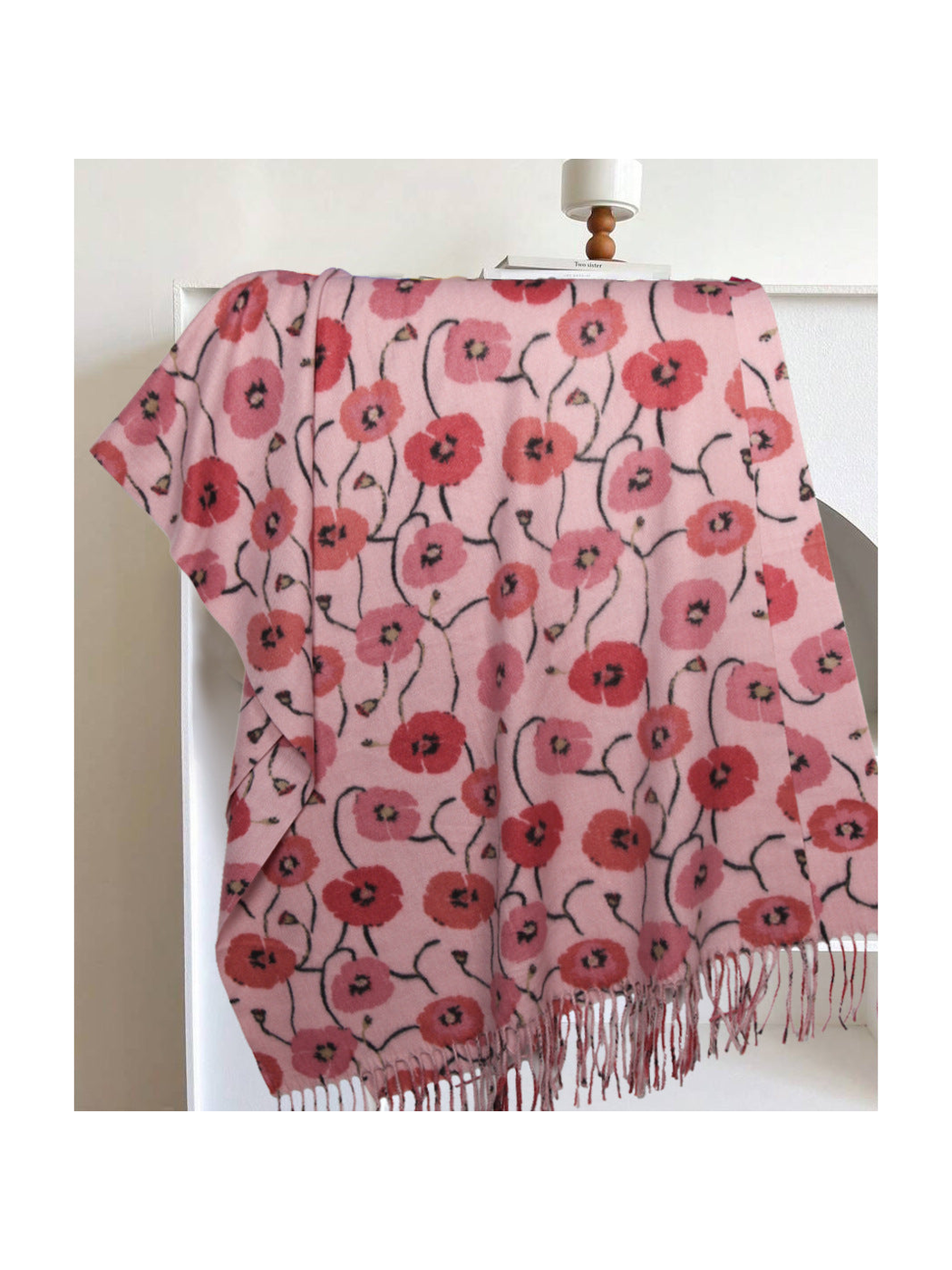 Light pink floral rectangular scarf with long fringe, draped display