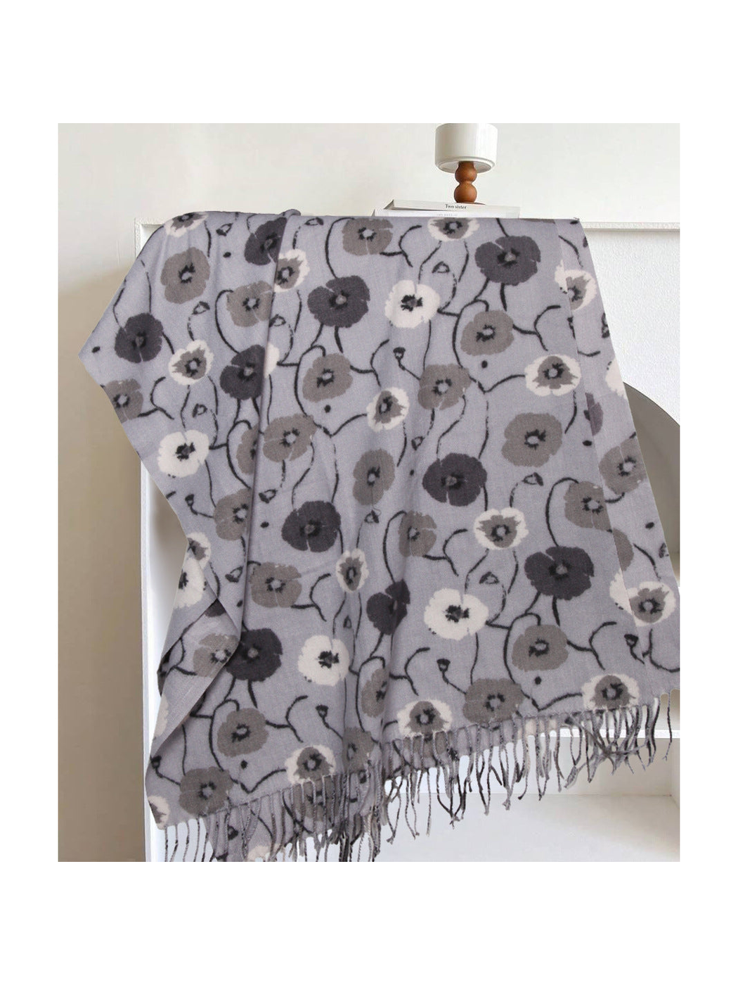 Light gray floral rectangular scarf with long fringe, draped display