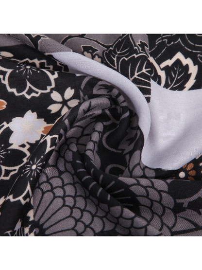 Close-up of the scarf's fine woven texture and overlapping printed folds