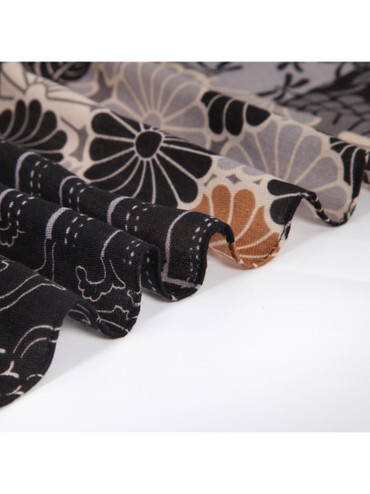 Close-up of the scarf's short fringed edge and printed patchwork border