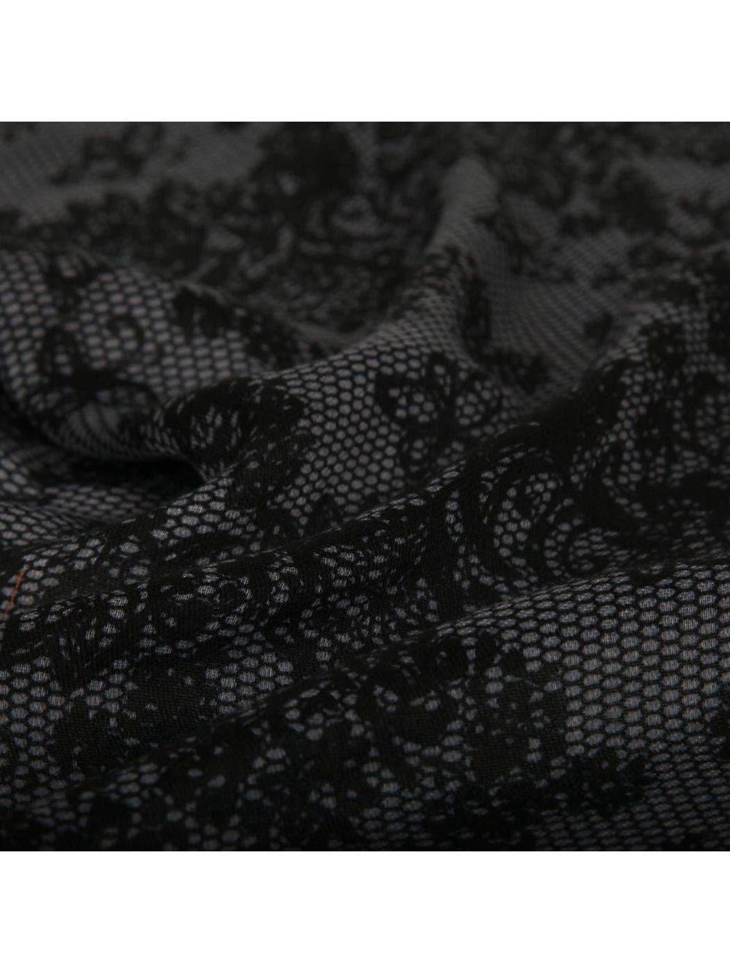 Close-up of the scarf's black floral motifs and mesh texture