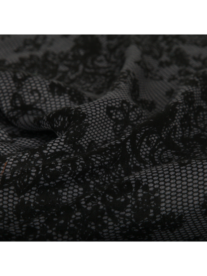 Close-up of the scarf's black floral motifs and mesh texture