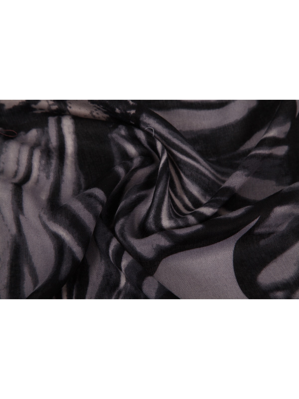 Close-up of the black and gray floral scarf gathered into soft folds