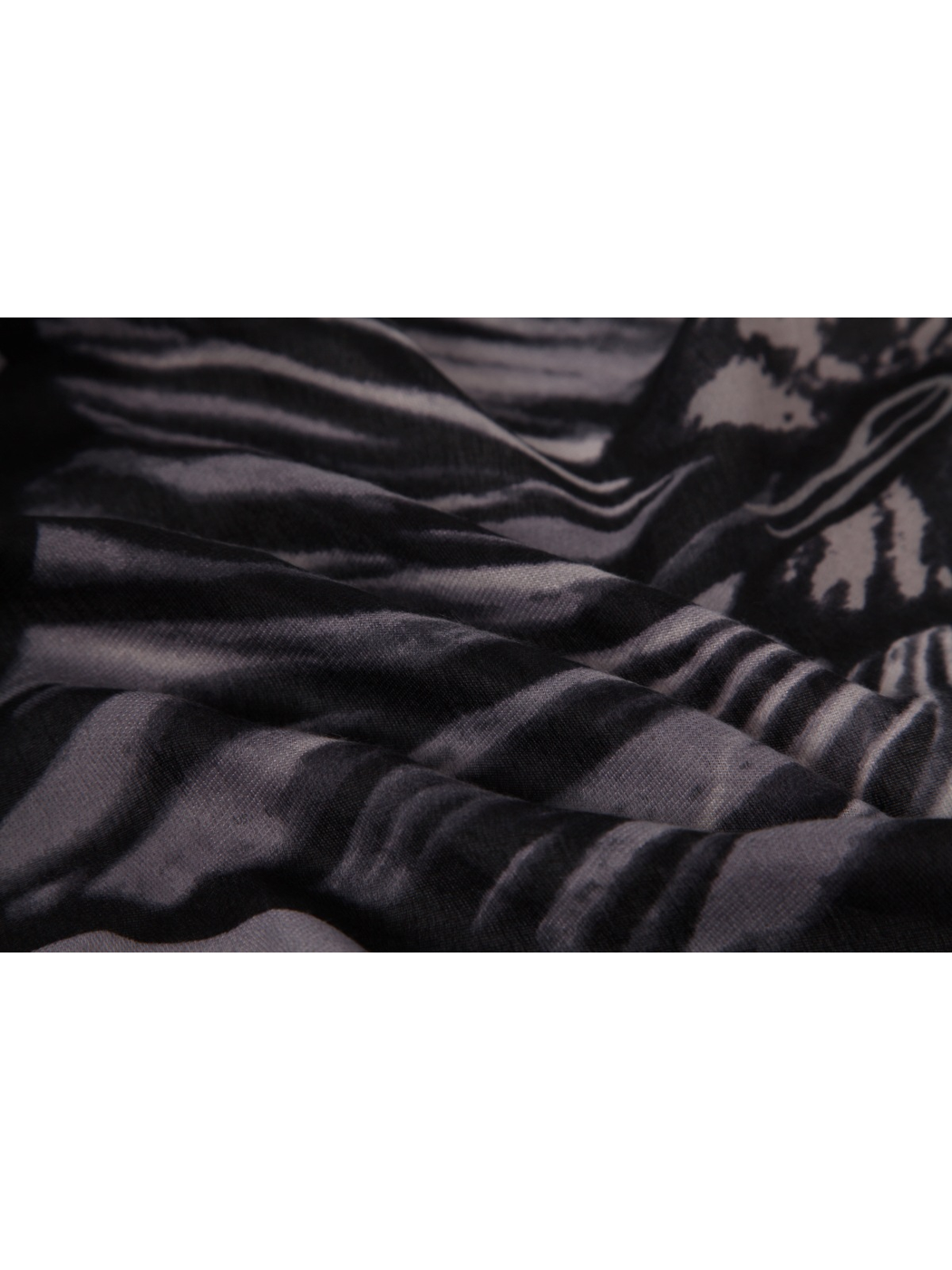 Close-up of the black and gray floral pattern across draped folds
