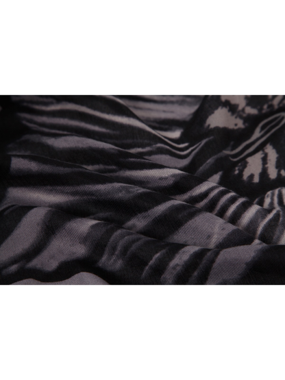 Close-up of the black and gray floral pattern across draped folds