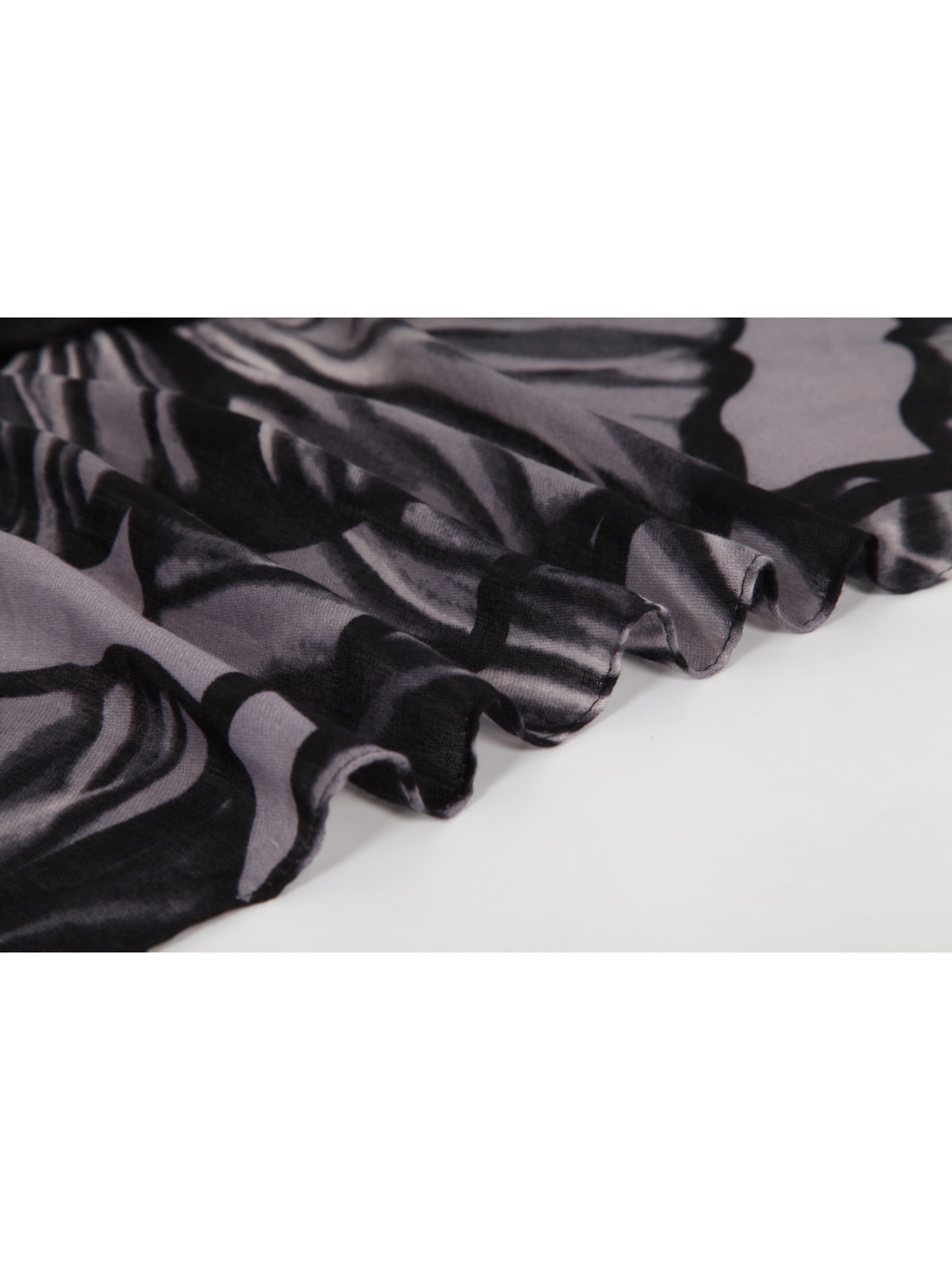 Close-up of the black and gray floral scarf with a short fringed edge