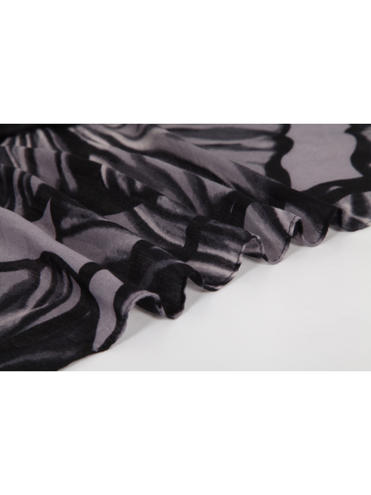 Close-up of the black and gray floral scarf with a short fringed edge