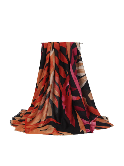 Black abstract botanical scarf with orange, red and pink accents, draped view