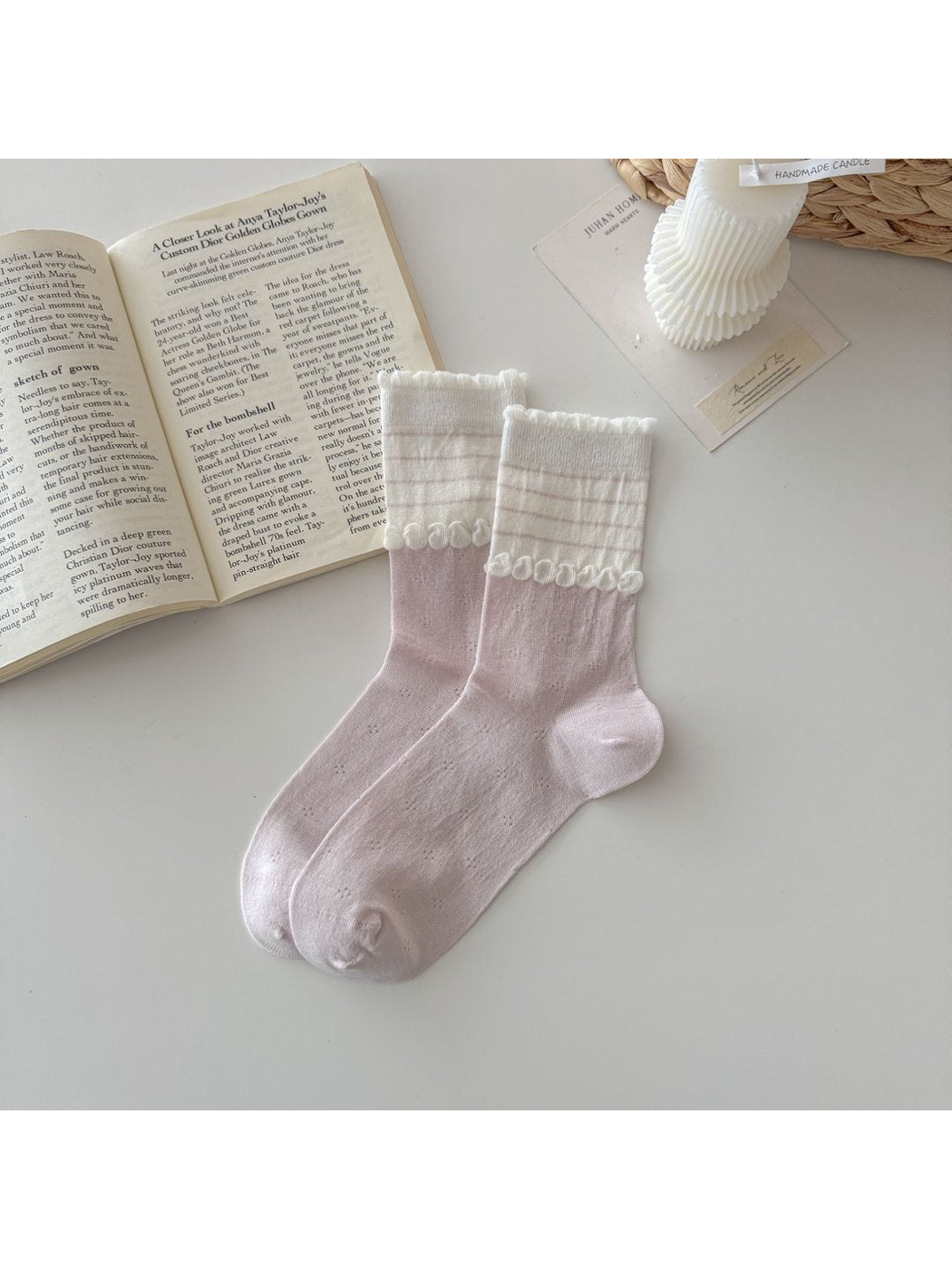 Light pink socks with white striped cuffs and looped trim
